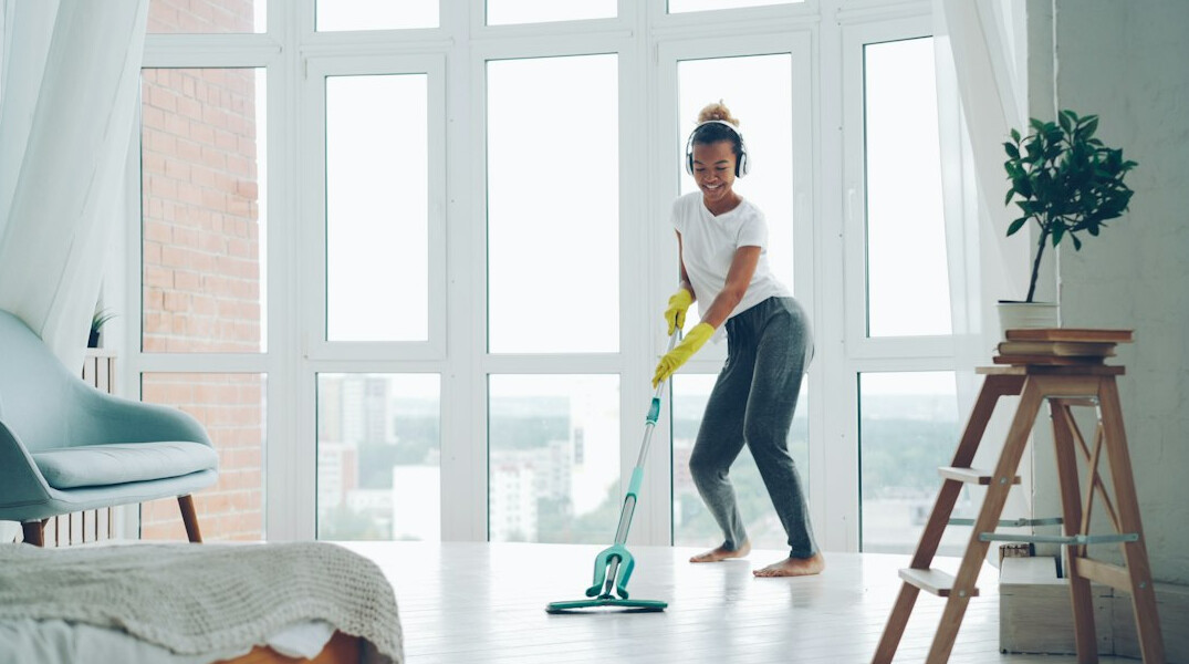 person mopping living room
